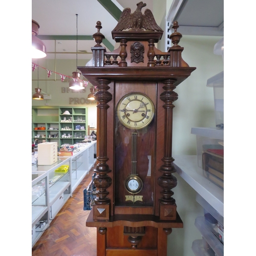 490 - Carved walnut Vienna-style wall clock, approx. 38 inches tall.