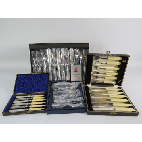 493 - Assorted boxed cutlery sets, including bone-handled and silver-plated examples.