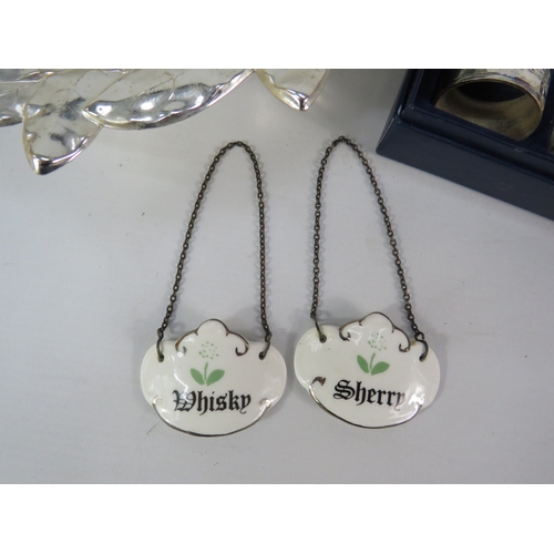 494 - Silver-plated leaf form serving bowl with napkin rings and decanter labels.