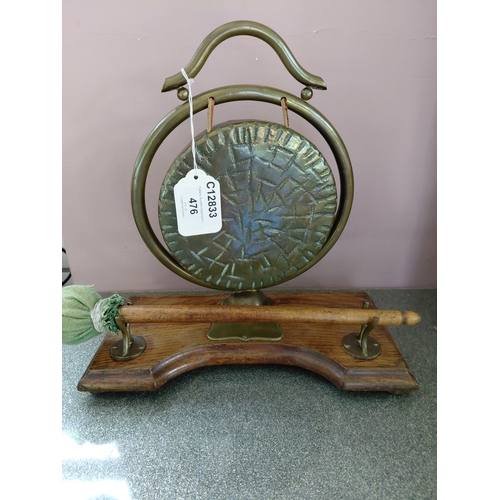 476 - Decorative brass gong with textured circular panel and wooden base, approx. 10 inches high, complete... 