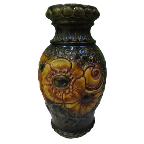 74 - A West German Pottery Vase 20 inches high A large moulded and relief decorated vase richly glazed in... 