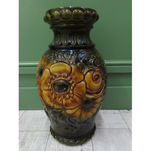 74 - A West German Pottery Vase 20 inches high A large moulded and relief decorated vase richly glazed in... 