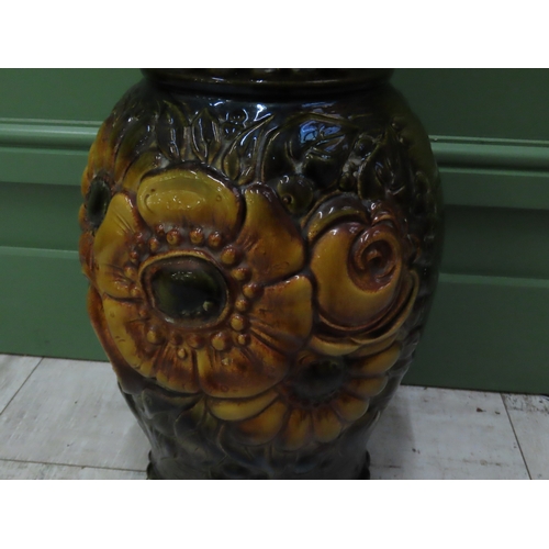 74 - A West German Pottery Vase 20 inches high A large moulded and relief decorated vase richly glazed in... 