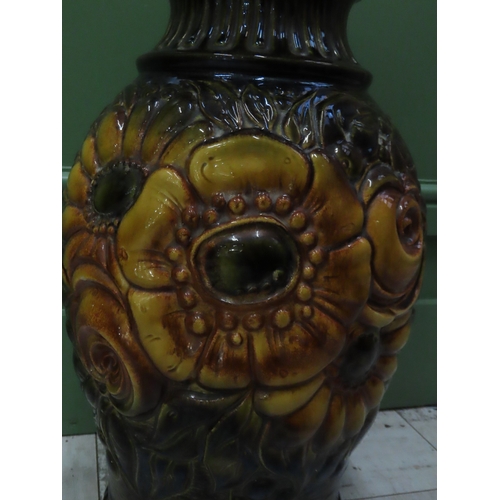 74 - A West German Pottery Vase 20 inches high A large moulded and relief decorated vase richly glazed in... 