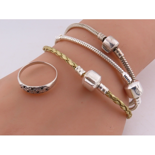 100 - A group of 925 silver bracelets and a ring, comprising two silver snake-link bracelets, a silver and... 