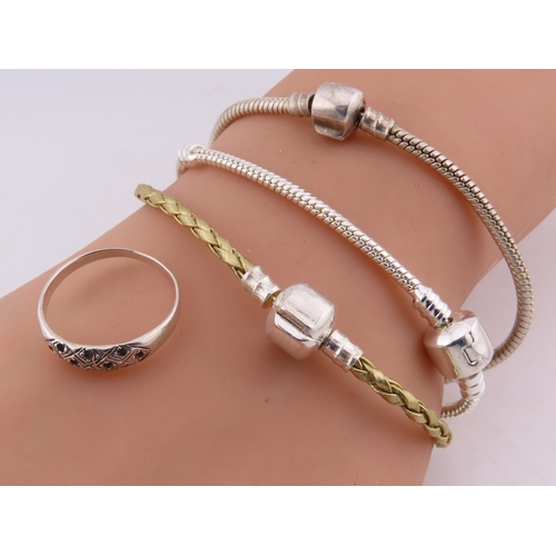 100 - A group of 925 silver bracelets and a ring, comprising two silver snake-link bracelets, a silver and... 
