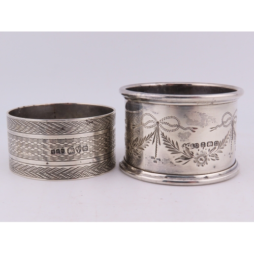 121 - Two sterling silver napkin rings, comprising a Birmingham example dated 1928 with engine-turned deco... 