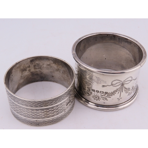 121 - Two sterling silver napkin rings, comprising a Birmingham example dated 1928 with engine-turned deco... 