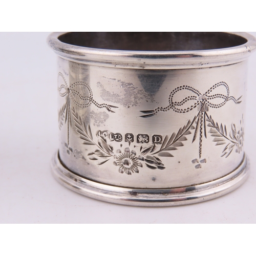 121 - Two sterling silver napkin rings, comprising a Birmingham example dated 1928 with engine-turned deco... 