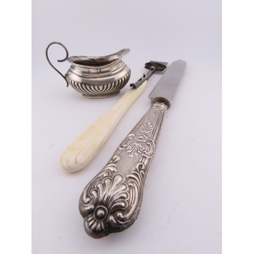 124 - A Georgian silver Stilton scoop with polished bone handle, together with a silver-handled cake knife... 