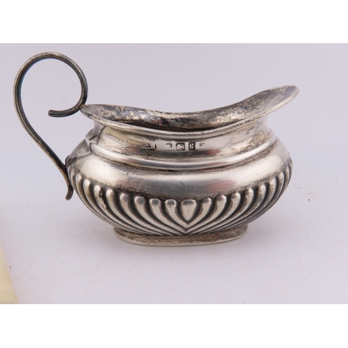 124 - A Georgian silver Stilton scoop with polished bone handle, together with a silver-handled cake knife... 