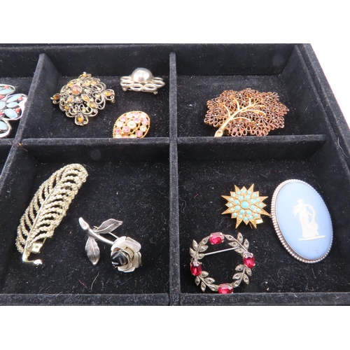 82 - Tray of vintage brooches A comprehensive assortment of brooches displayed in a compartmented tray, f... 