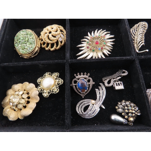 82 - Tray of vintage brooches A comprehensive assortment of brooches displayed in a compartmented tray, f... 