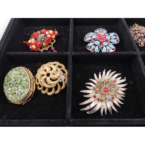 82 - Tray of vintage brooches A comprehensive assortment of brooches displayed in a compartmented tray, f... 
