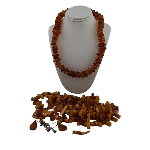 102 - A collection of amber and amber-style necklaces, including a graduated cognac amber-tone bead neckla... 