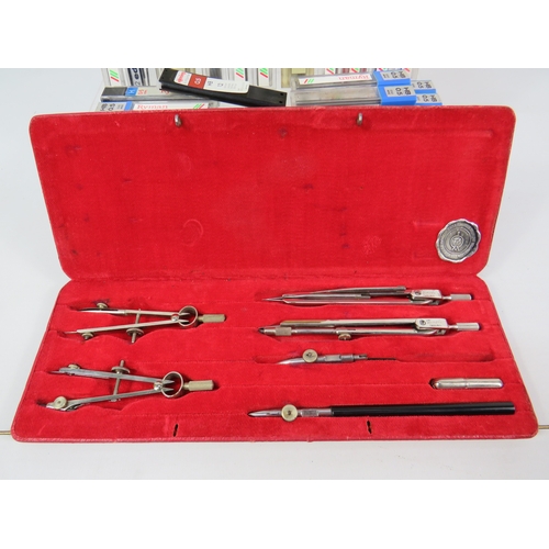 274 - Technical drawing equipment including compasses rulers set squares pencils in red metal case with wo... 