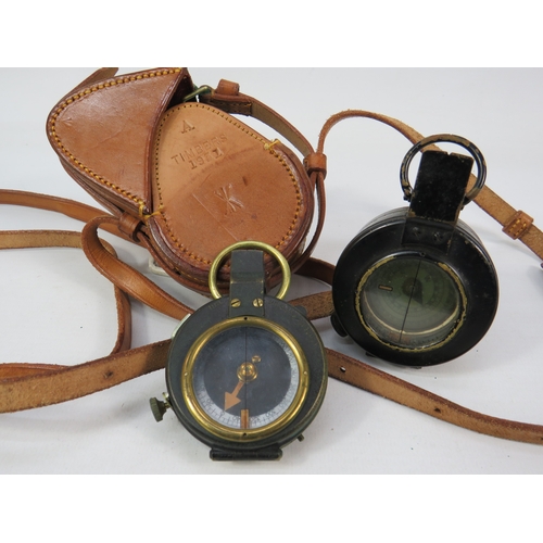 276 - Two vintage compasses with leather cases largest approximately 3 inches