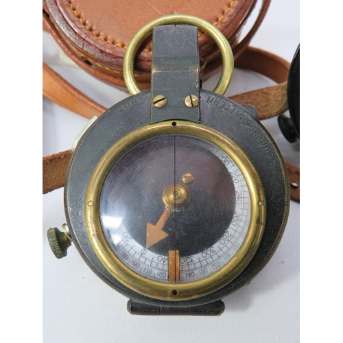 276 - Two vintage compasses with leather cases largest approximately 3 inches