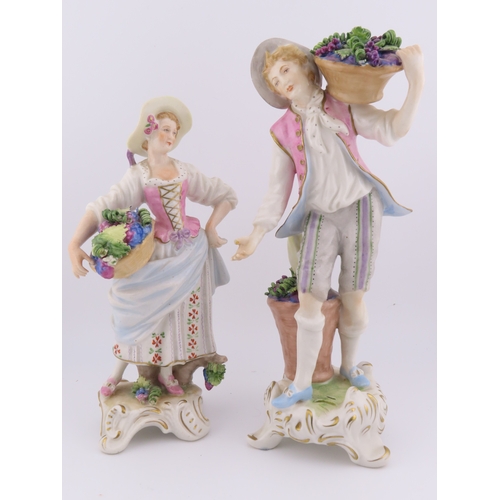 175 - Rudolf Kammer porcelain figures of a vineyard couple, the lady carrying a basket of grapes and the g... 