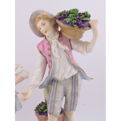 175 - Rudolf Kammer porcelain figures of a vineyard couple, the lady carrying a basket of grapes and the g... 