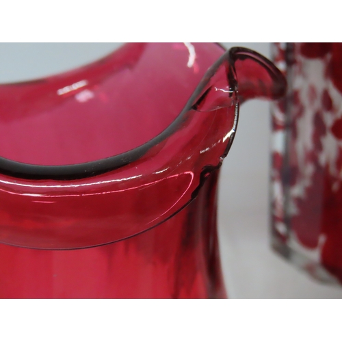 178 - Group of cranberry and ruby tinted glassware including three small cream jugs with clear loop handle... 