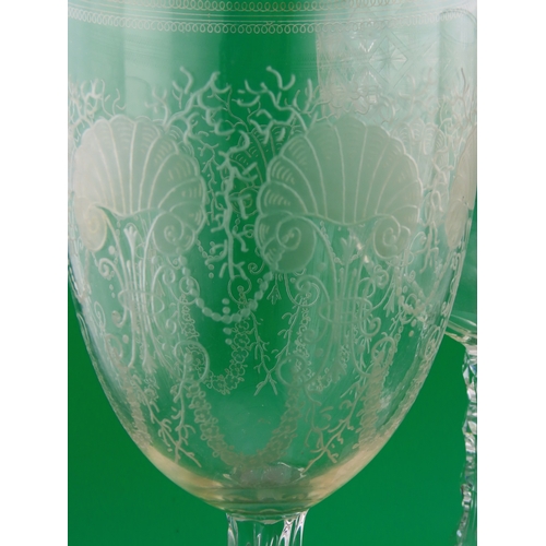 179 - Three large drinking glasses comprising a goblet with shell and scroll engraving, a faceted stem exa... 