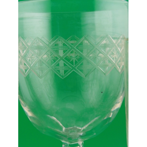 179 - Three large drinking glasses comprising a goblet with shell and scroll engraving, a faceted stem exa... 