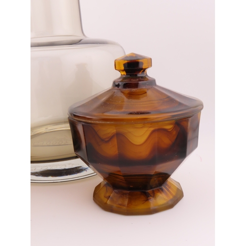 186 - Smoky glass decanter of modern cylindrical form with matching stopper together with two marbled ambe... 