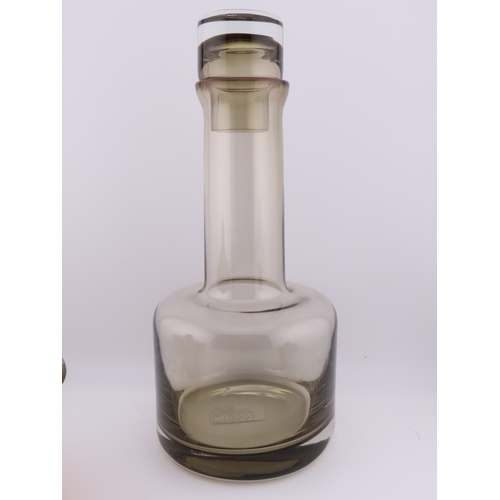 186 - Smoky glass decanter of modern cylindrical form with matching stopper together with two marbled ambe... 