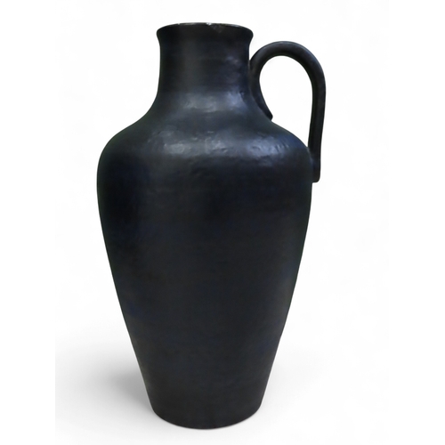 73A - Large textured blue West German pottery floor vase with loop handle approximately twenty three inche... 