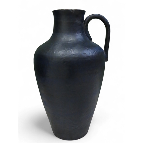 73A - Large textured blue West German pottery floor vase with loop handle approximately twenty three inche... 