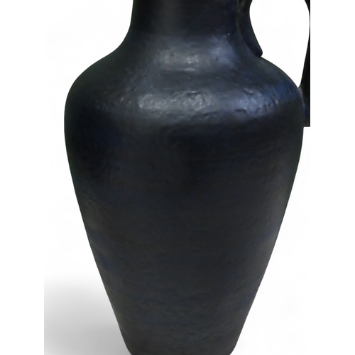 73A - Large textured blue West German pottery floor vase with loop handle approximately twenty three inche... 
