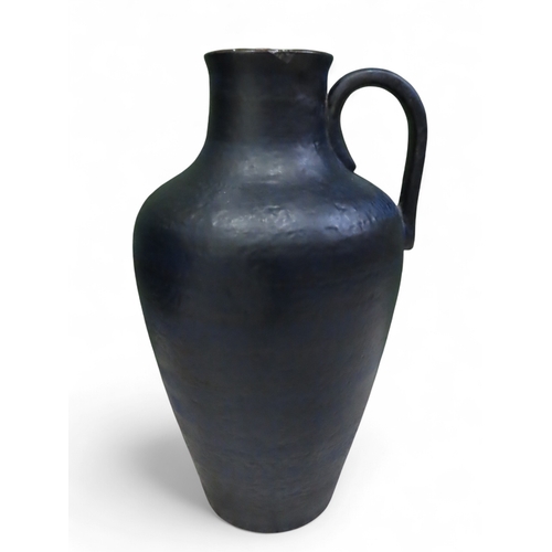 73A - Large textured blue West German pottery floor vase with loop handle approximately twenty three inche... 