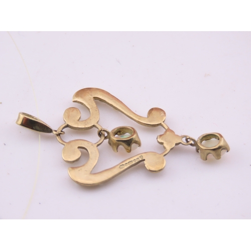 312 - A 9ct gold pendant of openwork heart form, set with opals and seed pearls. The stones displaying cha... 