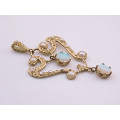 312 - A 9ct gold pendant of openwork heart form, set with opals and seed pearls. The stones displaying cha... 