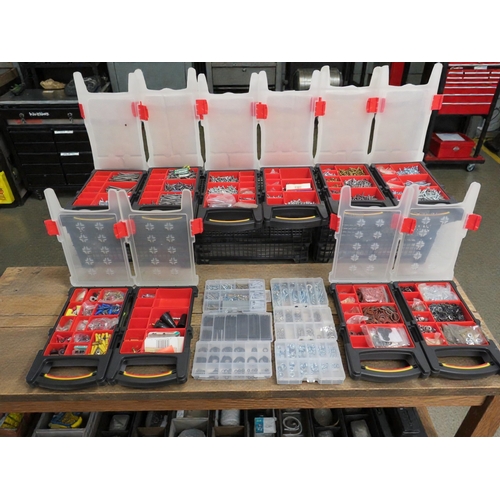 Sixteen storage organizer boxes with compartments containing assorted ...