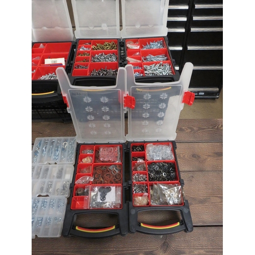 Sixteen storage organizer boxes with compartments containing assorted ...