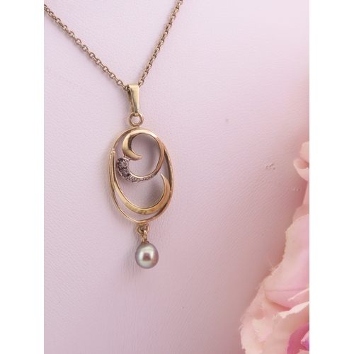 333 - A 9 carat gold diamond and pearl pendant necklace the pendant designed with a pearl drop and diamond... 