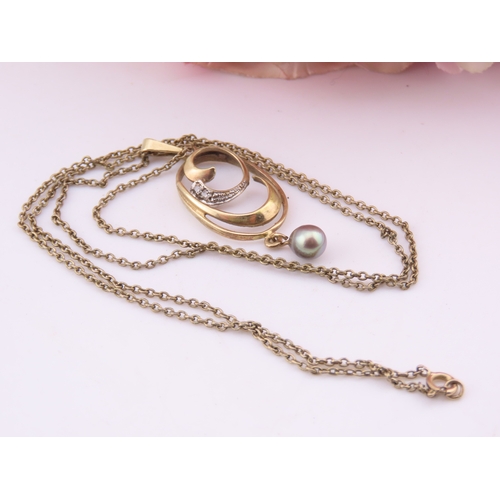 333 - A 9 carat gold diamond and pearl pendant necklace the pendant designed with a pearl drop and diamond... 