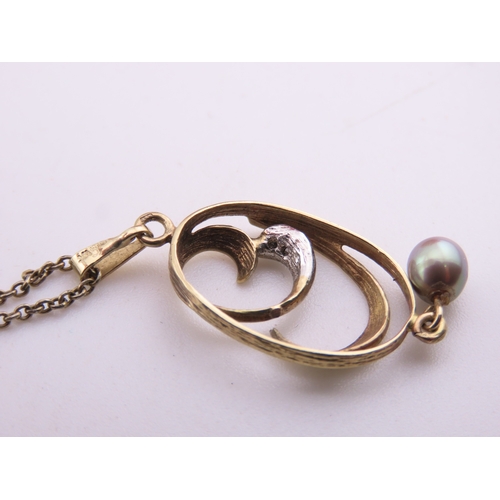 333 - A 9 carat gold diamond and pearl pendant necklace the pendant designed with a pearl drop and diamond... 