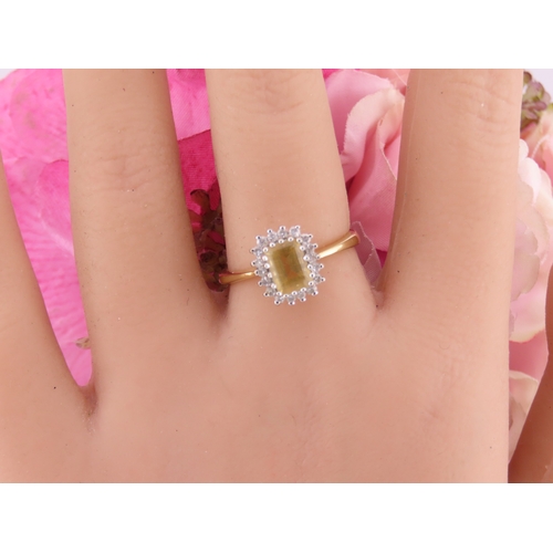 125 - An 18ct yellow gold ring claw set with a rectangular cut citrine accented by small brilliant cut dia... 