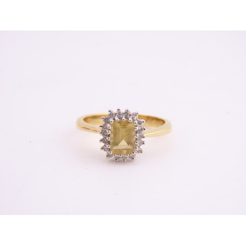 125 - An 18ct yellow gold ring claw set with a rectangular cut citrine accented by small brilliant cut dia... 