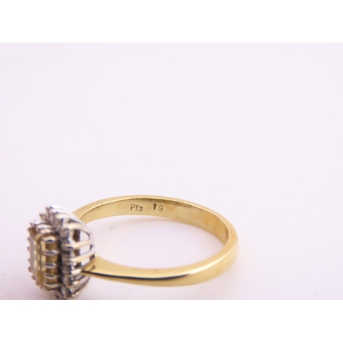 125 - An 18ct yellow gold ring claw set with a rectangular cut citrine accented by small brilliant cut dia... 