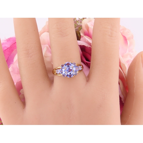 128 - A 9ct yellow gold ring set with an oval cut tanzanite in a claw mount with tapered shoulders. Ring s... 