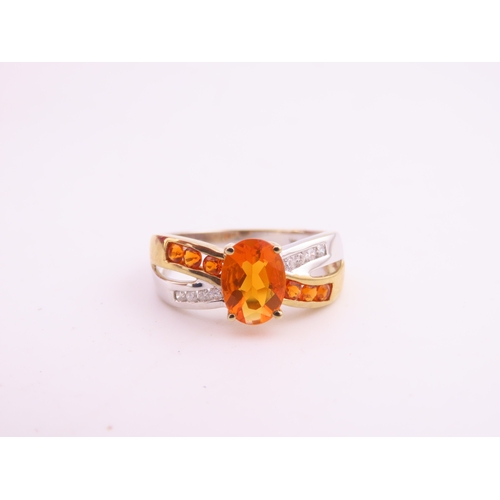 129 - A 9ct yellow and white gold ring set with an oval fire opal accented by small brilliant cut diamonds... 