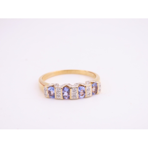 130 - A 14ct yellow gold ring set with rectangular cut tanzanites interspersed with small diamonds in a ch... 