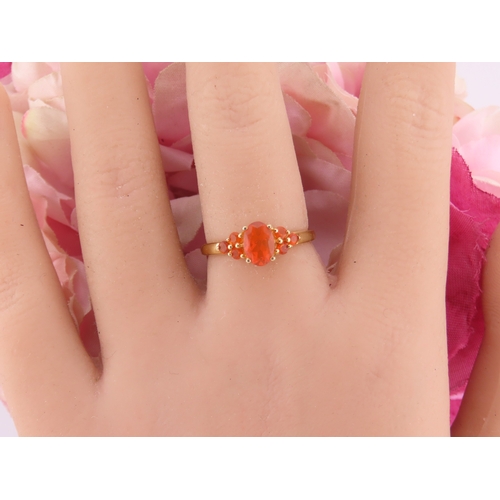 133 - A 9ct gold ring set with an oval fire opal within a decorative claw mount. Ring size M. Gross weight... 