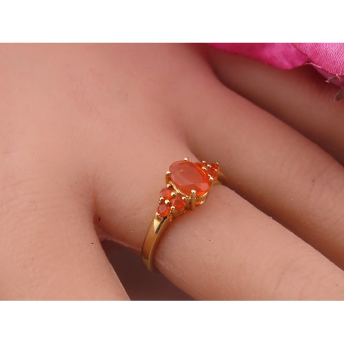 133 - A 9ct gold ring set with an oval fire opal within a decorative claw mount. Ring size M. Gross weight... 