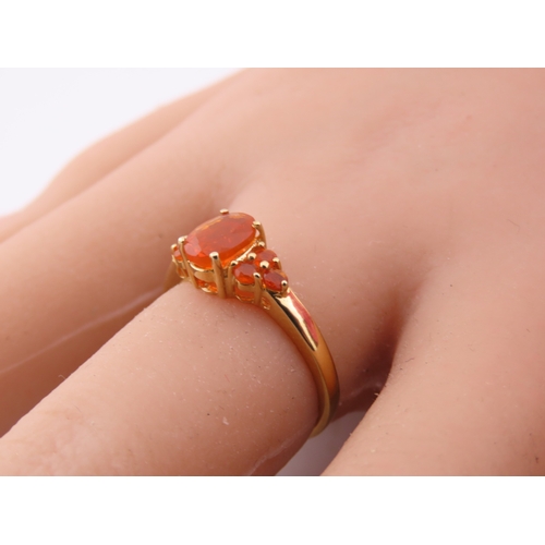 133 - A 9ct gold ring set with an oval fire opal within a decorative claw mount. Ring size M. Gross weight... 