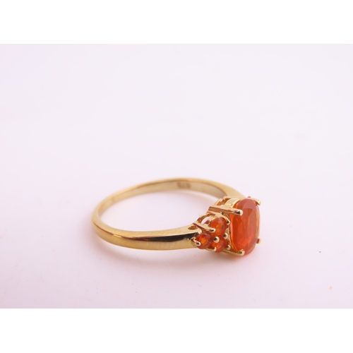 133 - A 9ct gold ring set with an oval fire opal within a decorative claw mount. Ring size M. Gross weight... 